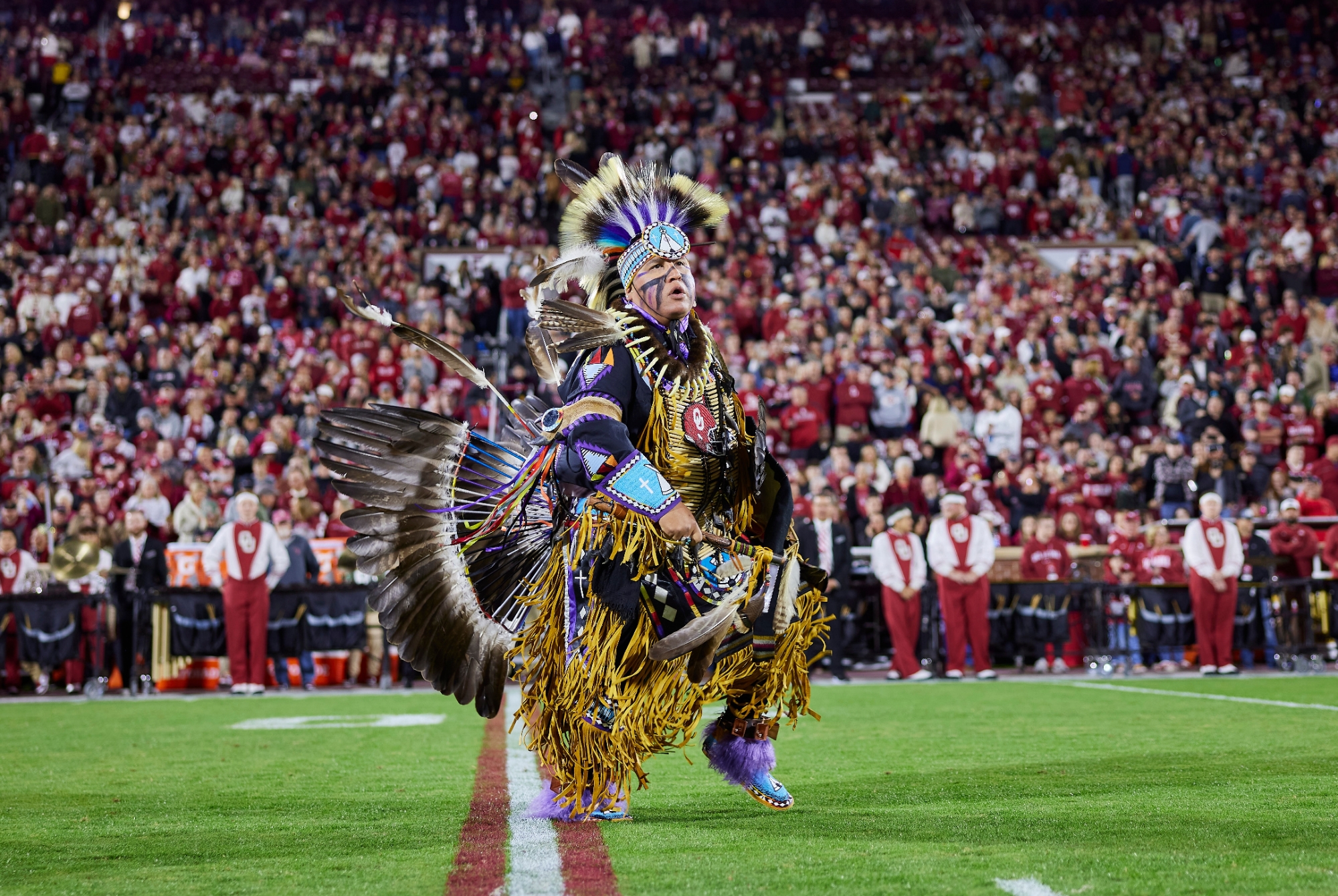 Man on football field in full regalia 