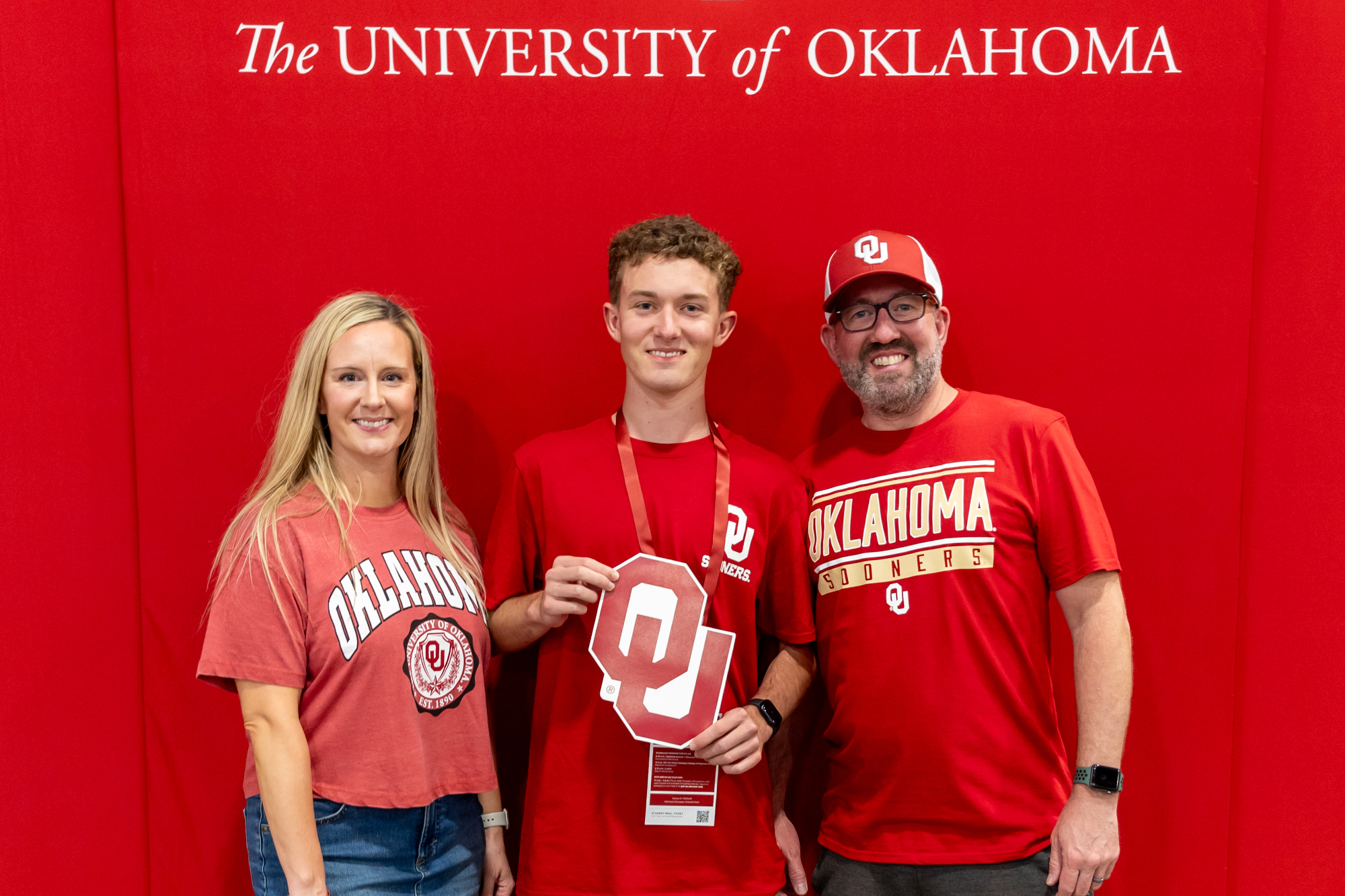 Student and supporters taking a picture with the OU logo