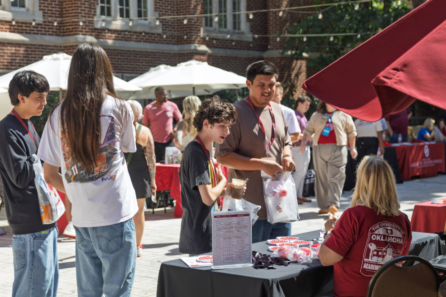 Prospective student talking to OU staff table at Sower's Day