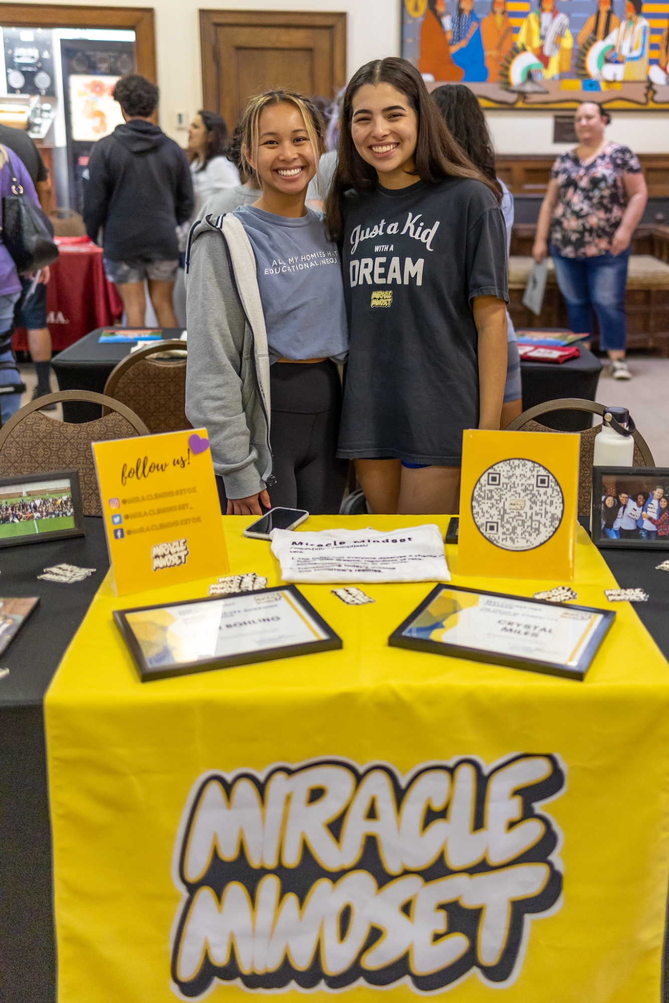 Two students posing at Miracle Mindset booth