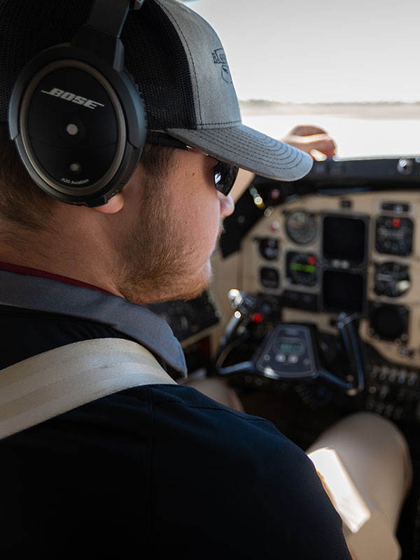 An aviation student in the cockpit of an aircraft.