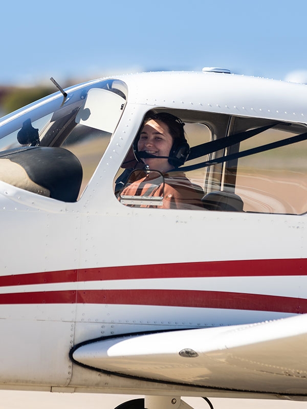 An OU aviation student in the cockpit of a Warrior III aircraft.