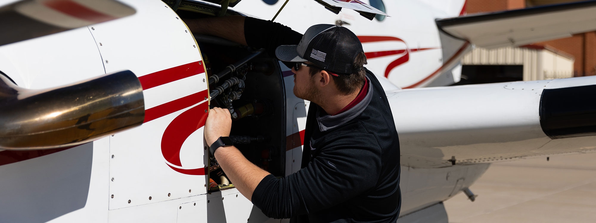 An aviation student performing maintenance on an airplane.