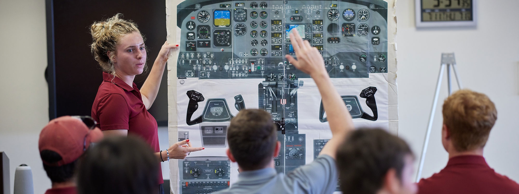 An instructor reviews a control panel image with students.