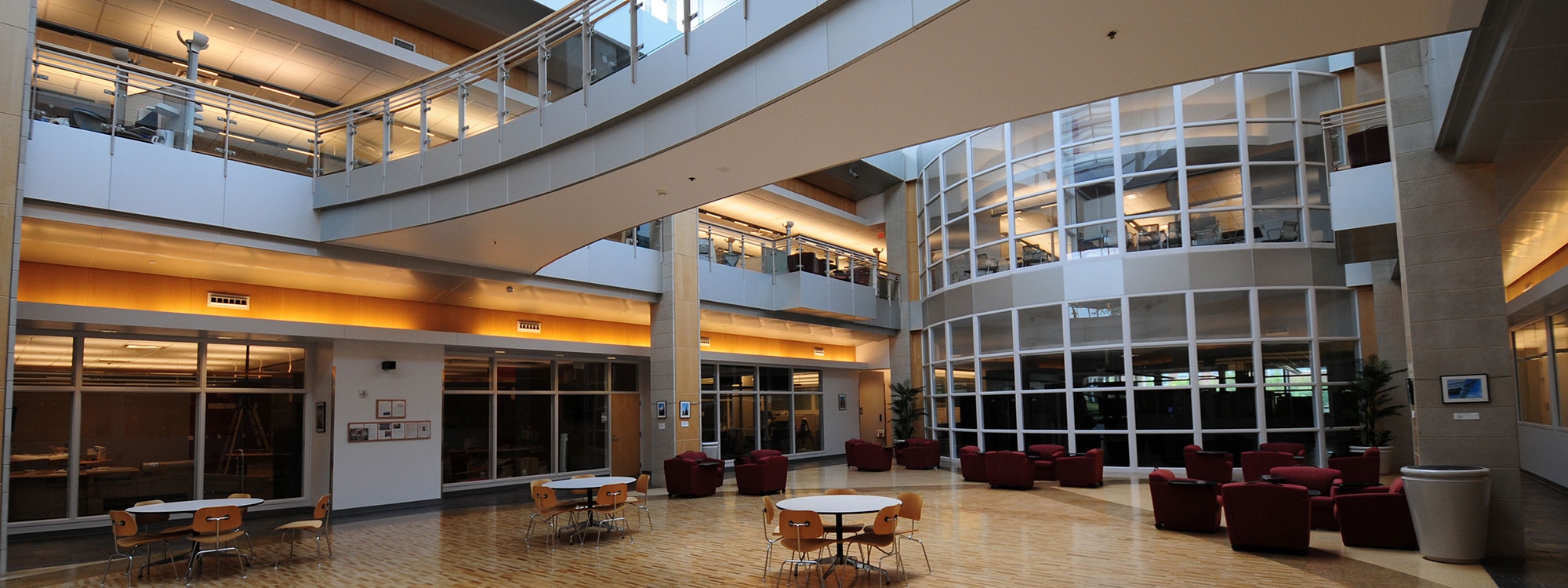An interior atrium of the Stephenson Research and Technology Center, with tables and chairs.