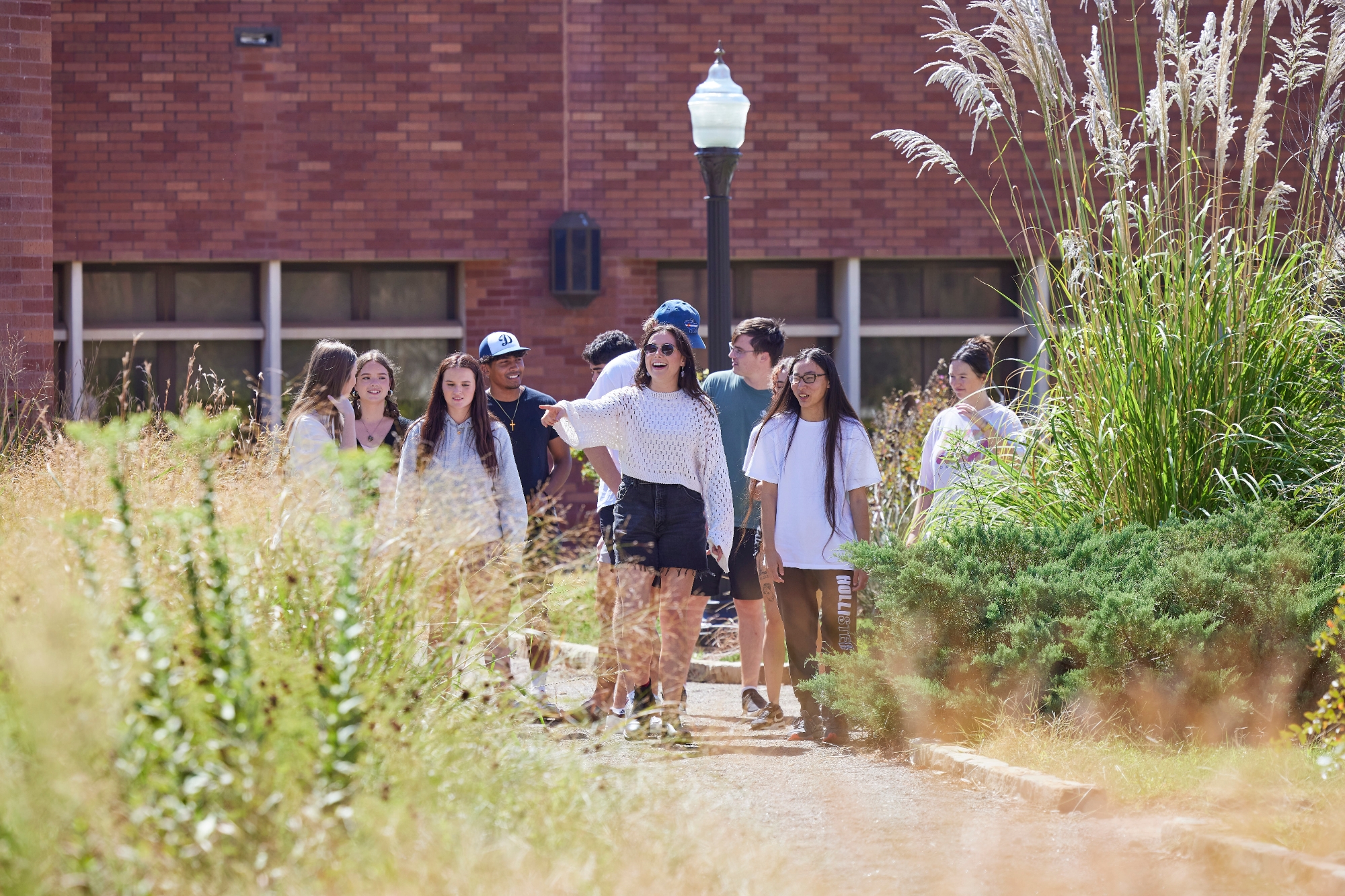 Students walking in a butterfly garden.
