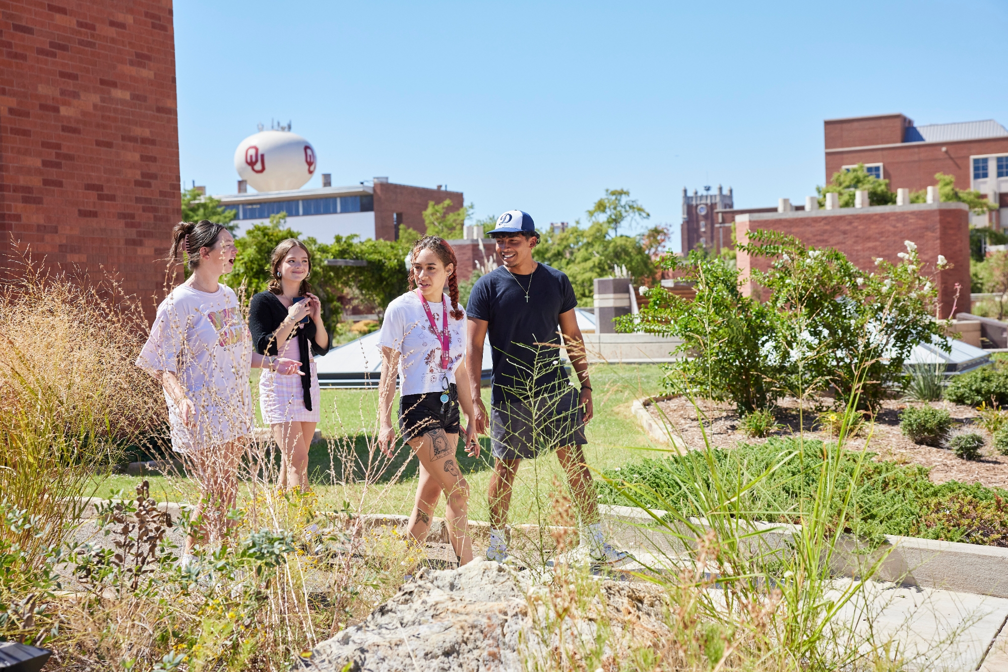 Students walking in a butterfly garden.