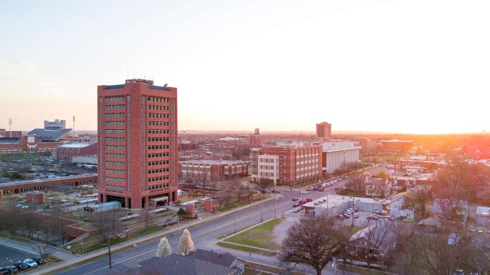 Sarkeys energy center building with sunset background.