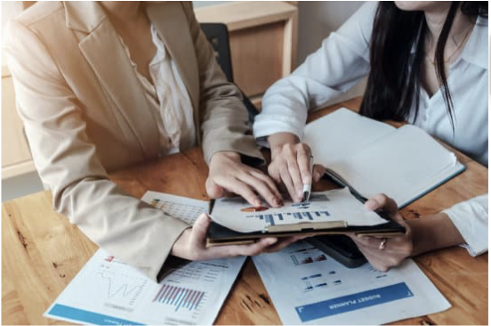 image of two people looking at a chart on a clipboard.