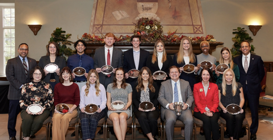 OU president and VP standing on either side of two rows of outstanding students!