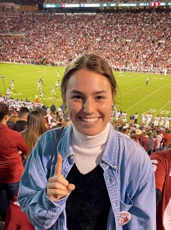 Juliana Mejia, attending an OU football game throwing up one finger like a champ!