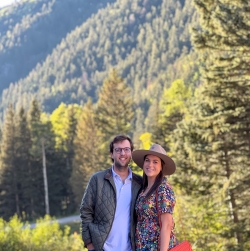 A photo of Grant Borelli and his wife with the lush forrest behind them.