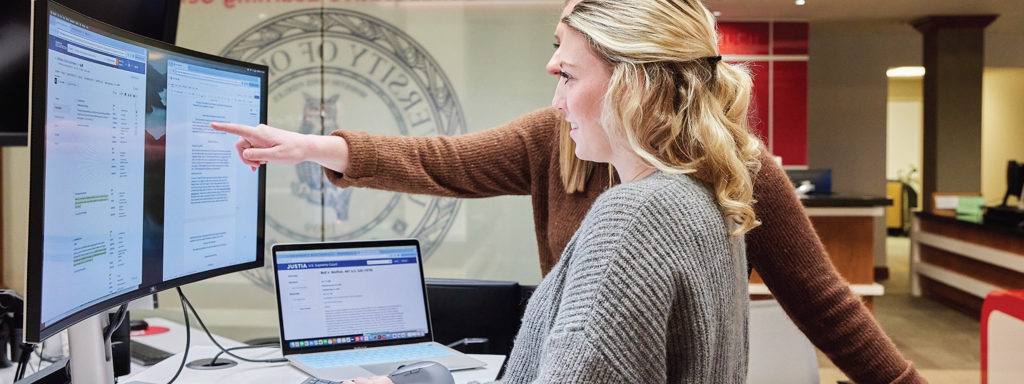 Two people working on a computer.