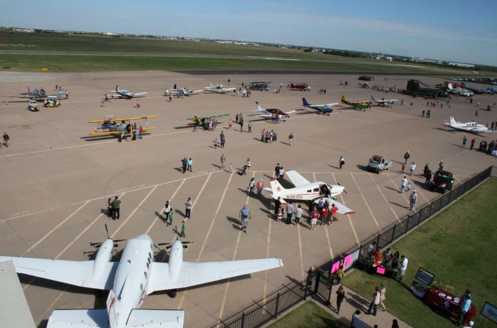 Static Aircraft displays with people walking around them on the Max Westheimer Airport Ramp
