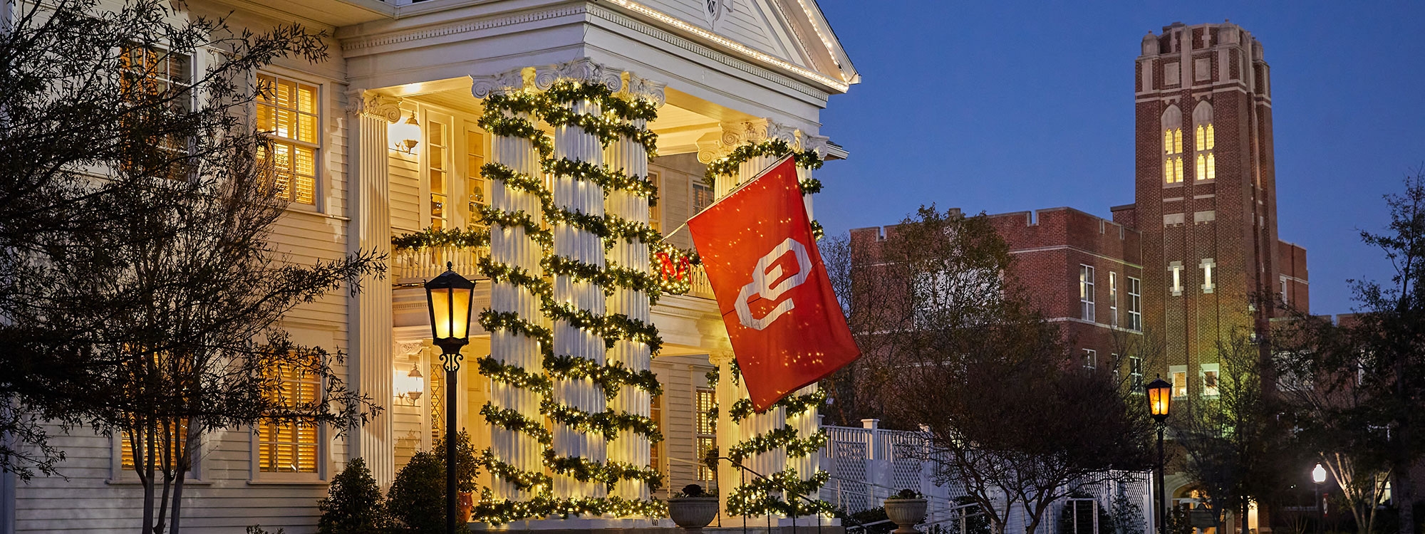 Boyd House decorated for the holidays, with Whitehand Hall in the background.