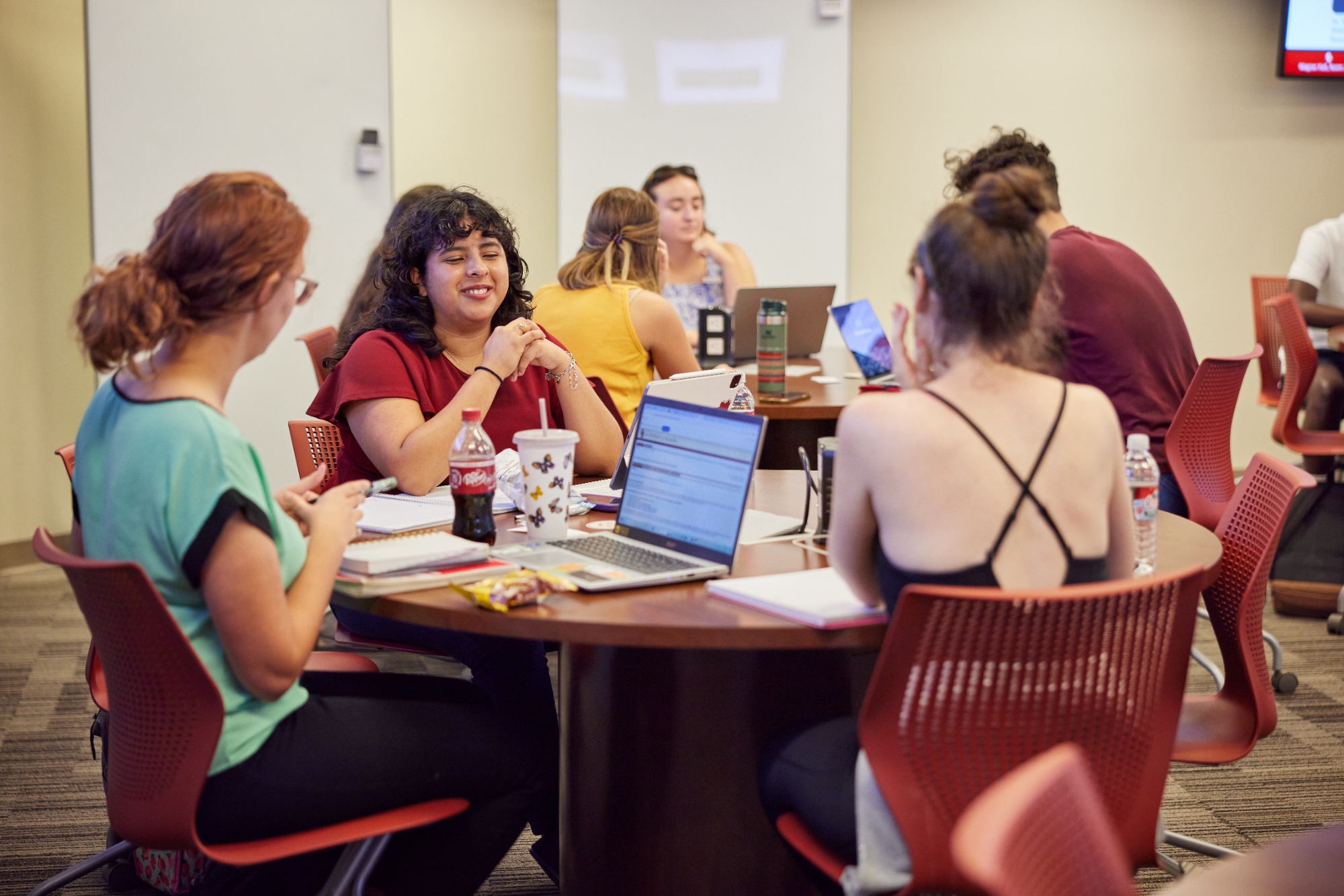 students are sitting around a table and talking