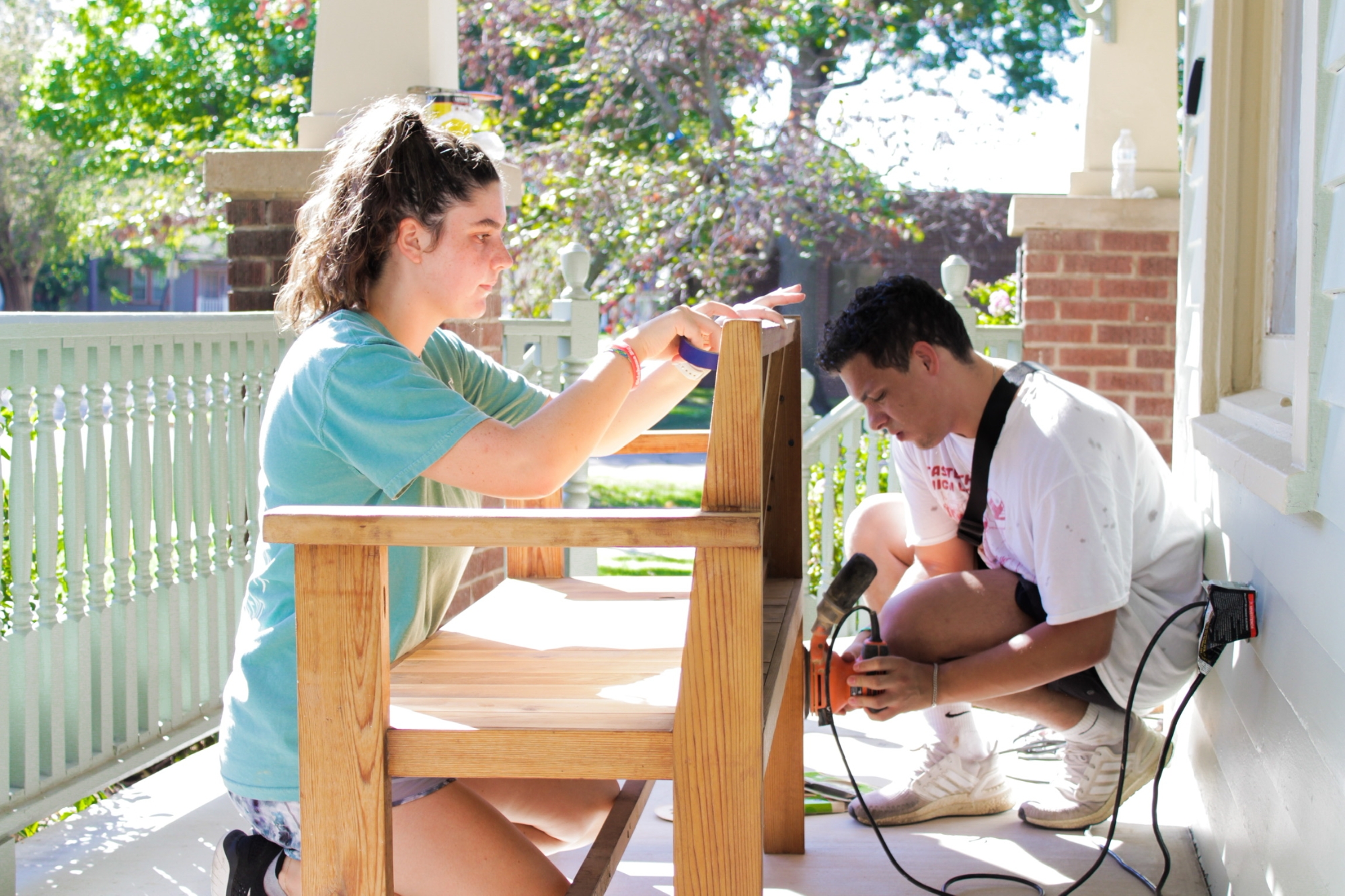 Students raking leaves while volunteering at The Big Event.