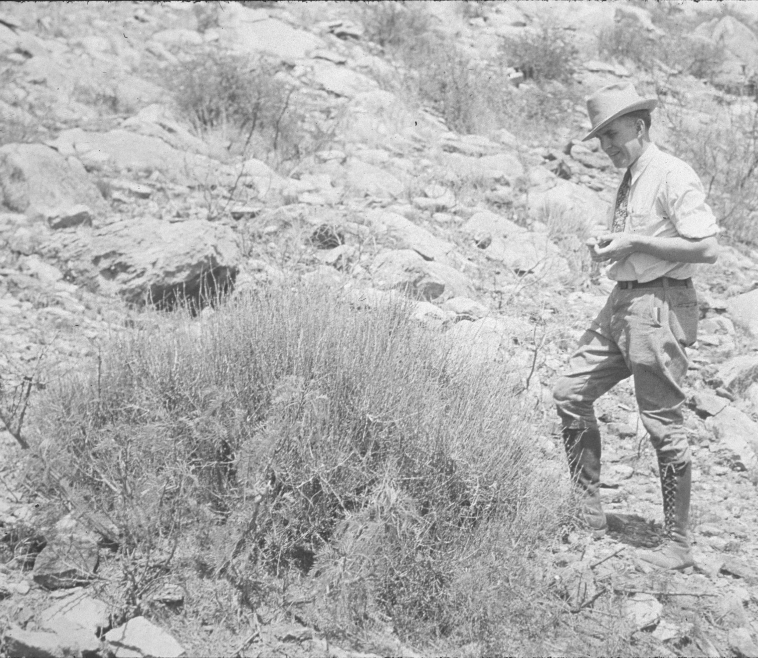 George Lynn Cross in tall boots and hat in the field, probably 1930s.