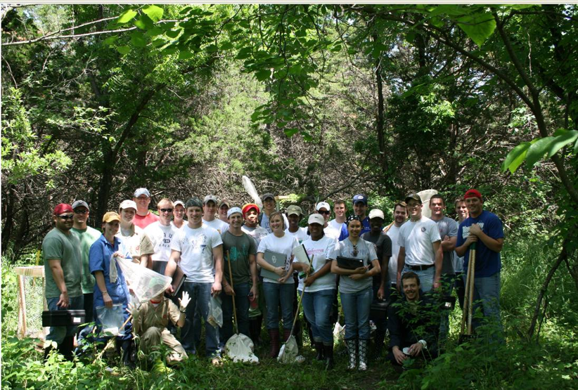 Class of students pose for group picture in Oliver's Woods.