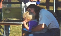 Child and mom looking at fish in glass tank