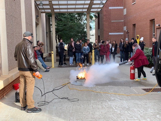Fire safety training using an extinguisher.