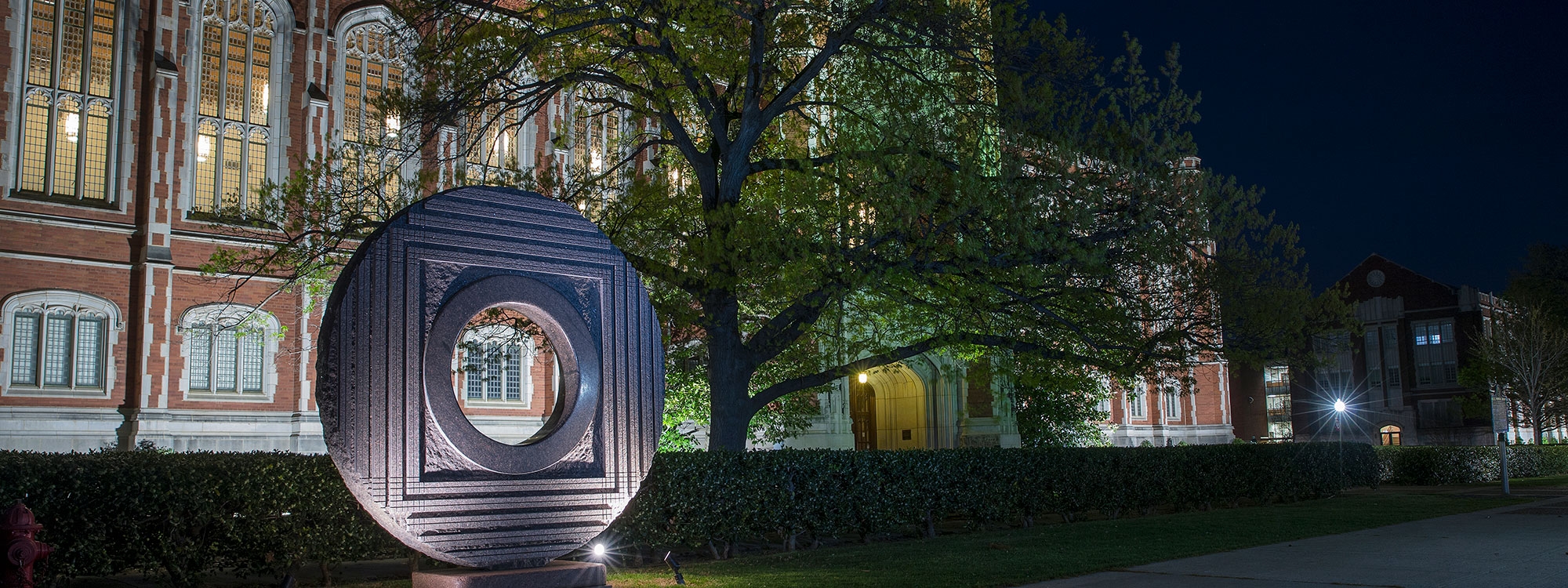 The front of the Bizzell memorial library at night.