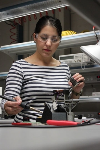 Student using soldering gun