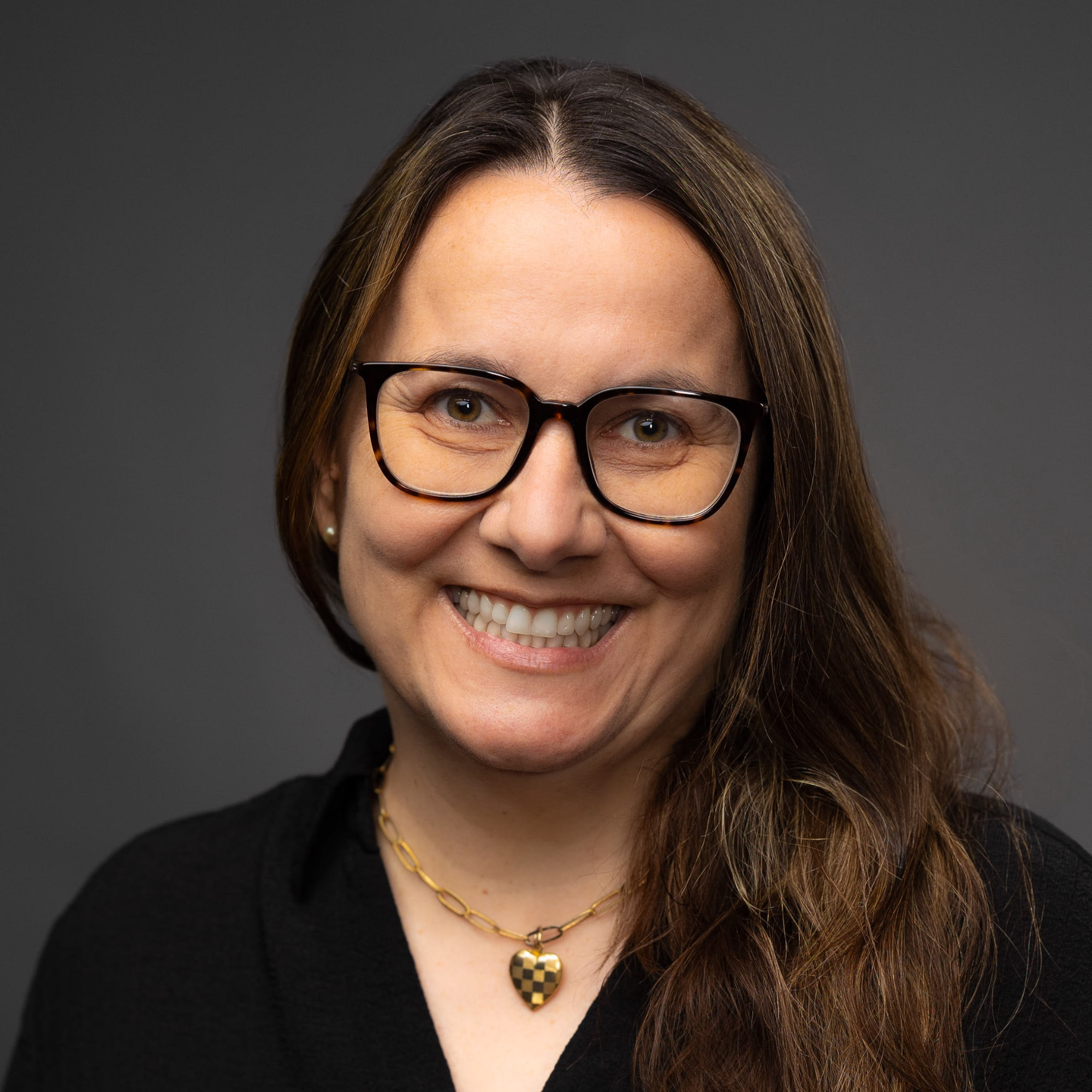 White and green flowers on campus with building in the background.
