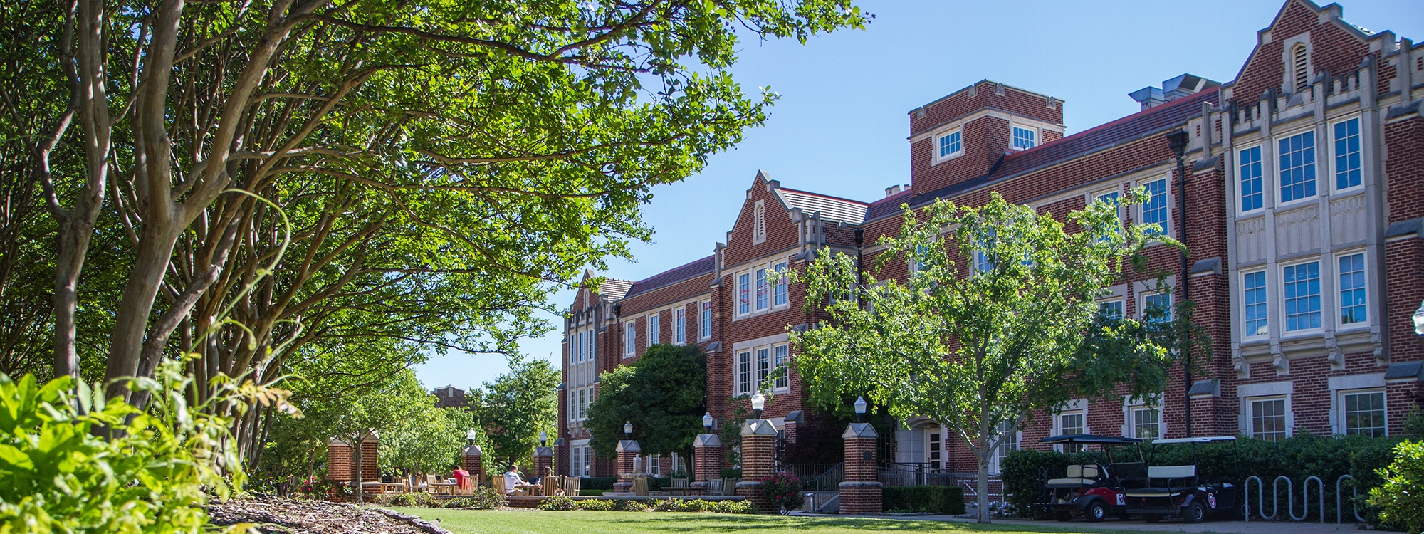 The exterior of Ellis Hall, surrounded by a blue sky and greenery.