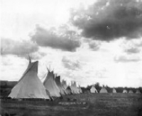 A line of teepees in black and white.