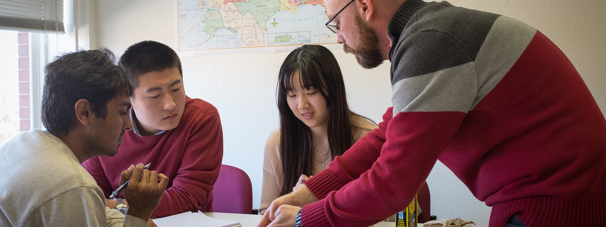 Students Working in Language Learning Center with an instructor.
