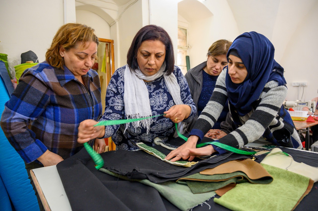 March 2, 2020; Georgette Habashi (left) works with artisans Shireen Mansour, Abeer Dauod and Doaa Fayyad at Child's Cup Full in Zababdeh, a village located in the northern West Bank. (Photo by Barbara Johnston/University of Notre Dame)