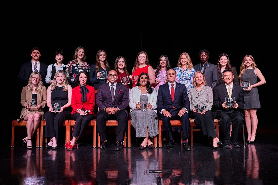 Sixteen seniors who received the Outstanding Senior Award