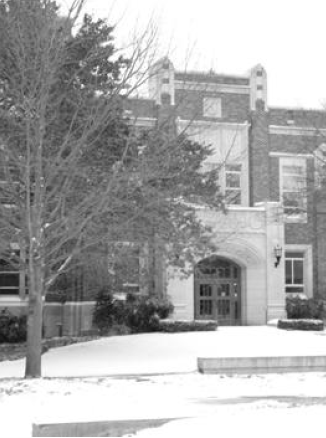 A black and white photo of west Nielsen Hall under snowfall.