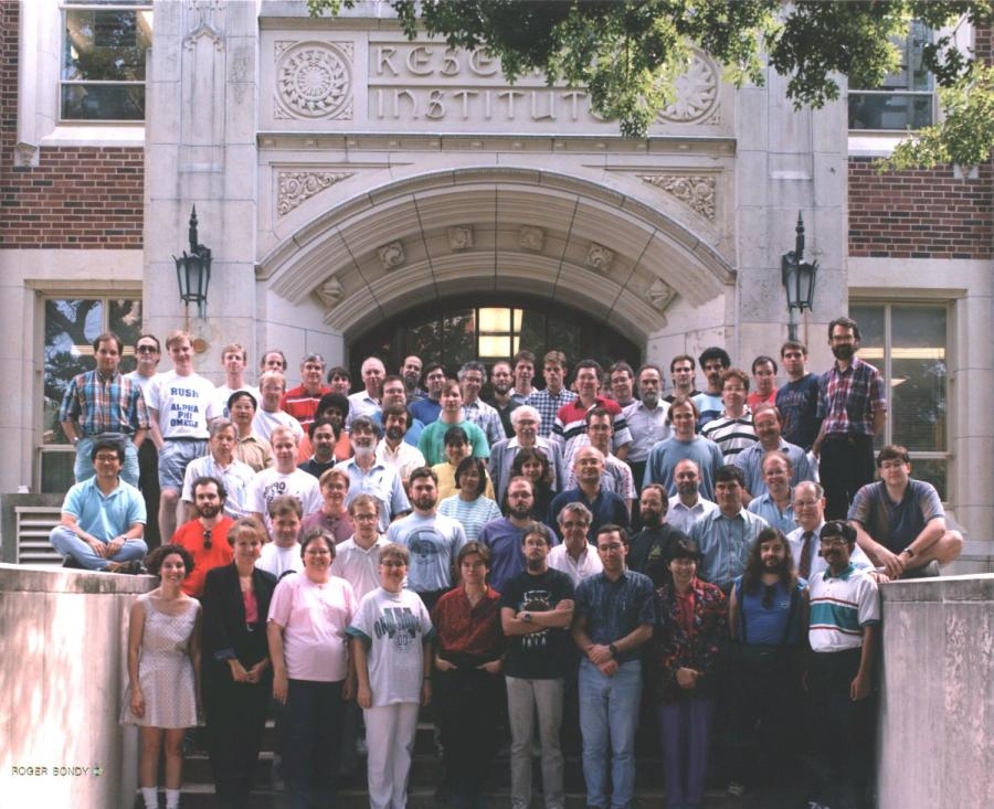 Group photo from the 1994-1995 school year, taken outside in front of the Research Institute arch of Nielsen Hall.