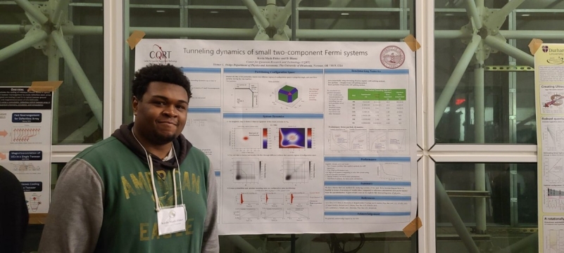 A photo of Kevin Mack-Fisher in front of his poster at ITAMP/B2.
