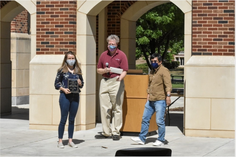 A photo of Jamie Boyd accepting their award.