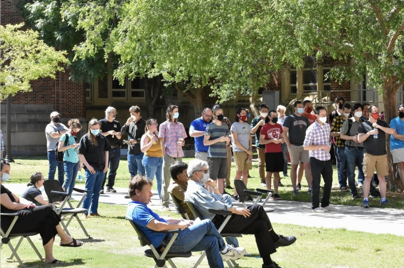 Students, staff, and faculty sitting and standing outside during the awards.