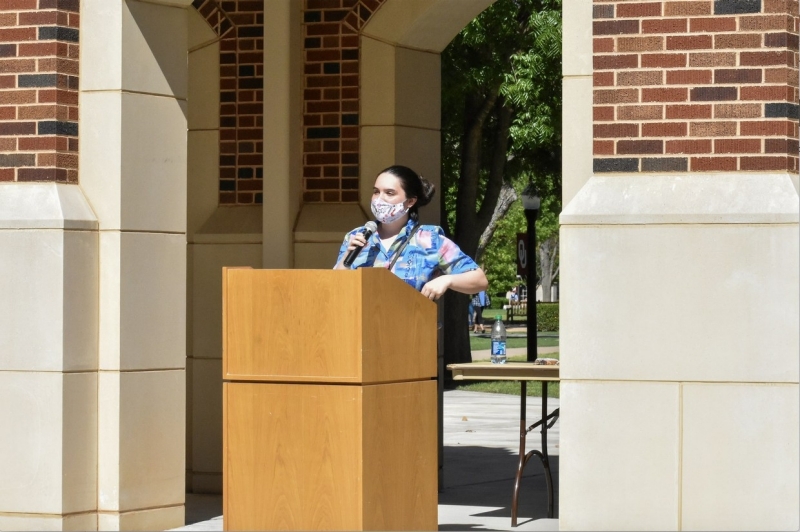 A photo of London Wilson at the podium.