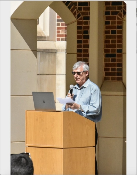 A photo of Phil Gutierrez at the podium, addressing the department.