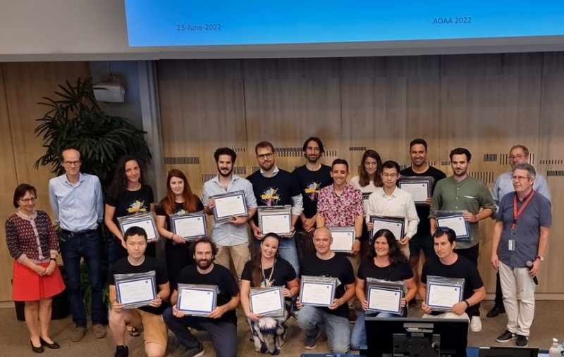 A large group of people holding up their Outstanding Achievement Awards at CERN.