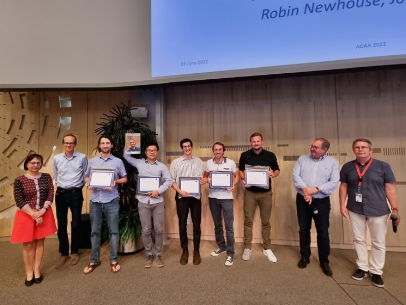 A group of people holding up their Outstanding Achievement Awards at CERN.