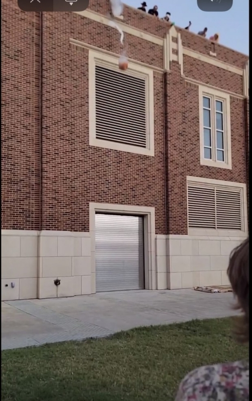 Pumpkin being dropped from the roof of Nielsen Hall.