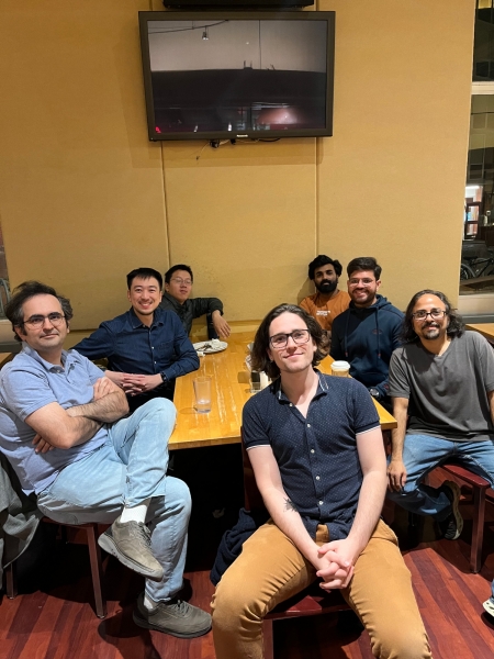 A small group from the High Energy Physics research group enjoying a meal at a restaurant.
