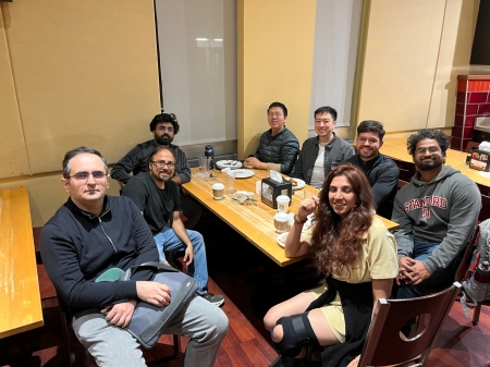 A small group from the High Energy Physics research group enjoying a meal at a restaurant.