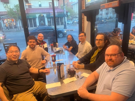 A small group from the High Energy Physics research group enjoying a meal at a restaurant.