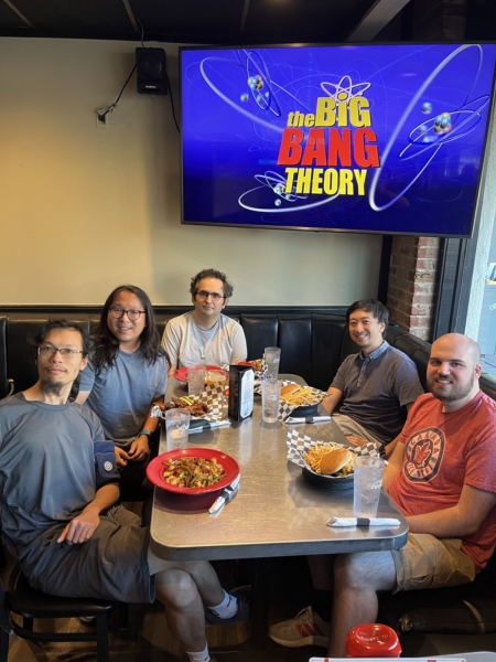 A small group from the High Energy Physics research group enjoying a meal at a restaurant.