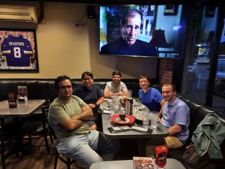 A small group from the High Energy Physics research group enjoying a meal at a restaurant.