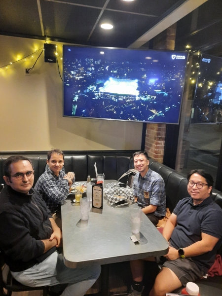 A small group from the High Energy Physics research group enjoying a meal at a restaurant.