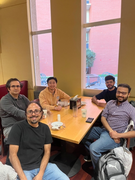 A small group from the High Energy Physics research group enjoying a meal at a restaurant.